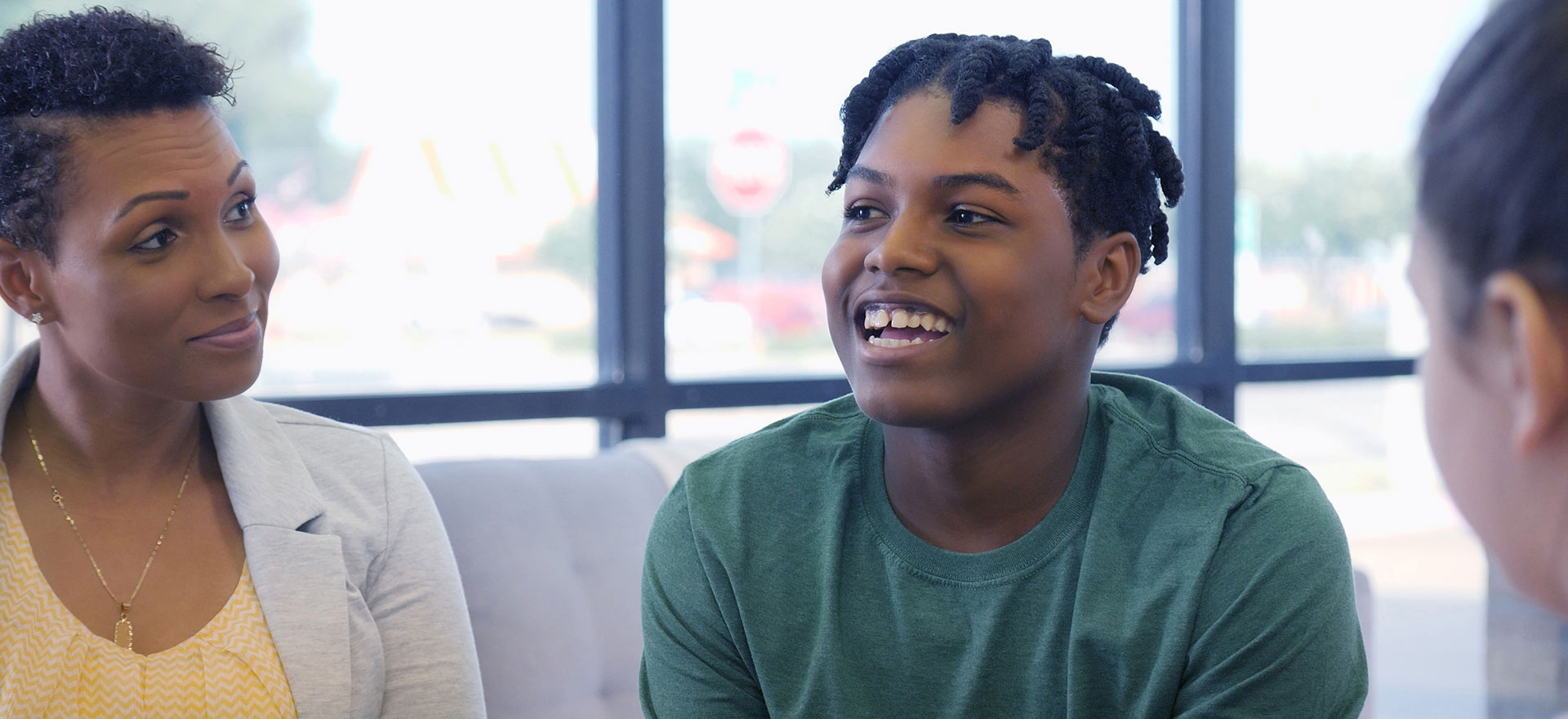 A teenager and his mother attend group therapy session
