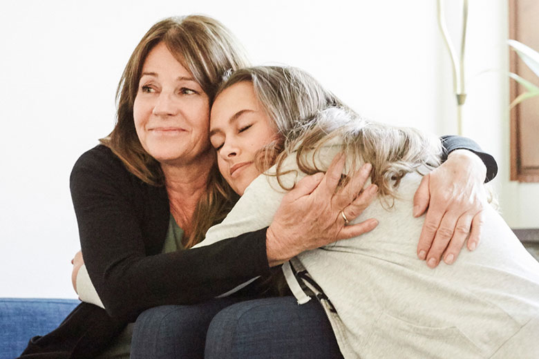 Mother and daughter hugging